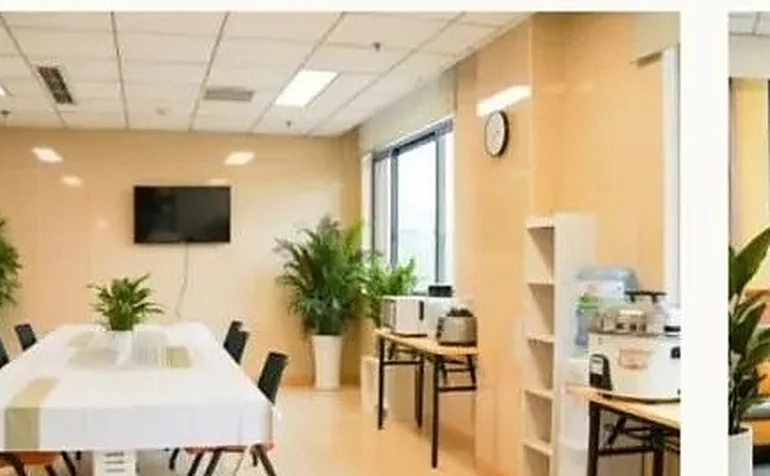 Patient day lounge with dining area and television